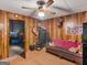 Basement featuring wood paneled walls, carpet, a large gun safe, and mounted deer heads at 930 Singley Dr, Locust Grove, GA 30248