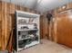Basement with a white bookcase against wood paneling and tan carpet at 930 Singley Dr, Locust Grove, GA 30248