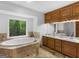 Elegant bathroom with double sinks, soaking tub and large window with tree view at 930 Singley Dr, Locust Grove, GA 30248