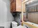 Upstairs bathroom with dark wood vanity, updated toilet, and vanity lighting at 930 Singley Dr, Locust Grove, GA 30248