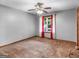 Neutral bedroom featuring a ceiling fan, plush carpet and bright window at 930 Singley Dr, Locust Grove, GA 30248