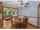 Cozy dining room featuring a wooden table and chairs, a ceiling fan, and access to the living room at 930 Singley Dr, Locust Grove, GA 30248