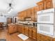 Eat-in kitchen features wooden cabinets, granite countertops, and modern appliances, creating a functional space at 930 Singley Dr, Locust Grove, GA 30248