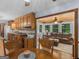 Traditional eat-in kitchen with wood cabinetry and a view to the sunroom at 930 Singley Dr, Locust Grove, GA 30248