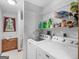 Bright laundry room with washer, dryer, and organized shelving for storage at 930 Singley Dr, Locust Grove, GA 30248