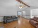 Bright living room featuring hardwood floors, neutral walls, and comfortable seating arrangement at 930 Singley Dr, Locust Grove, GA 30248