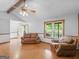 Inviting living room featuring hardwood floors, a cozy seating area, and a view of the landscaped yard at 930 Singley Dr, Locust Grove, GA 30248
