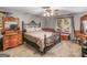 Neutral main bedroom with a ceiling fan, plush carpet and a bright window at 930 Singley Dr, Locust Grove, GA 30248