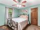 Cozy main bedroom with a ceiling fan, plush carpet, and a bright window at 930 Singley Dr, Locust Grove, GA 30248