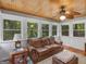 Inviting sunroom with wood ceiling, natural light from windows, and a comfortable leather sofa at 930 Singley Dr, Locust Grove, GA 30248
