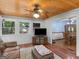 Bright sunroom boasting wood ceiling, multiple windows, a leather sofa, and decorative details at 930 Singley Dr, Locust Grove, GA 30248