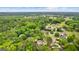 An aerial view shows houses surrounded by trees within a community, highlighting the area's lush landscape at 105 Riviera Ct, Fayetteville, GA 30215