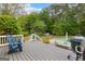 Wood deck with seating overlooks in-ground pool and spacious backyard at 105 Riviera Ct, Fayetteville, GA 30215