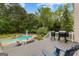 Spacious backyard with in-ground pool, deck, seating and barbeque grill at 105 Riviera Ct, Fayetteville, GA 30215