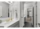 Bathroom featuring dark tiled floor, neutral vanity, and framed mirror at 105 Riviera Ct, Fayetteville, GA 30215
