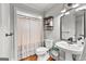 Well-lit bathroom features a pedestal sink, and a decorative shower curtain at 105 Riviera Ct, Fayetteville, GA 30215