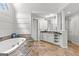 Bright bathroom featuring a soaking tub, large vanity, and elegant tile flooring at 105 Riviera Ct, Fayetteville, GA 30215
