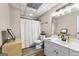 Bright bathroom features a single sink vanity, decorative mirror and patterned tile ceiling at 105 Riviera Ct, Fayetteville, GA 30215