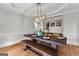 Elegant dining room with a rustic wood table, bench seating, and stylish light fixture at 105 Riviera Ct, Fayetteville, GA 30215