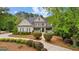 Stunning two-story home featuring a welcoming front porch and lush landscaping at 105 Riviera Ct, Fayetteville, GA 30215