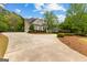 Exterior of home with manicured lawn, a long driveway, and lush landscaping, offering an inviting curb appeal at 105 Riviera Ct, Fayetteville, GA 30215
