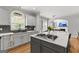 Kitchen features stainless appliances, gray cabinets, granite countertops, and island with range at 105 Riviera Ct, Fayetteville, GA 30215