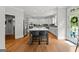 Bright kitchen features stainless appliances, gray cabinets, island with seating, and hardwood floors at 105 Riviera Ct, Fayetteville, GA 30215