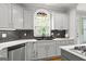 Kitchen features stainless appliances, gray cabinets, granite countertops, and breakfast bar seating at 105 Riviera Ct, Fayetteville, GA 30215
