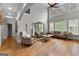 Bright living room with tall ceilings, large windows, hardwood floors, and comfortable seating at 105 Riviera Ct, Fayetteville, GA 30215
