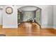 Bright living room featuring hardwood floors, an arched doorway, and ample natural light at 105 Riviera Ct, Fayetteville, GA 30215