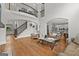 Spacious open-concept living room with a staircase, large windows, and hardwood floors at 105 Riviera Ct, Fayetteville, GA 30215