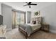 Primary bedroom featuring a ceiling fan, neutral carpet, and window at 105 Riviera Ct, Fayetteville, GA 30215