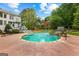 A spacious backyard featuring a pool, a stone water feature, and lush greenery, perfect for outdoor relaxation and entertainment at 105 Riviera Ct, Fayetteville, GA 30215