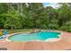 An in-ground pool features a waterfall and plenty of room for sunbathing and recreation at 105 Riviera Ct, Fayetteville, GA 30215