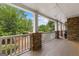 Relaxing covered porch with stone accents and beautiful outdoor views at 105 Riviera Ct, Fayetteville, GA 30215