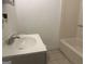 Bathroom featuring a single sink vanity, a standard tub with shower, and neutral-toned tile flooring at 8833 Thomas Rd, Jonesboro, GA 30238