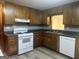 Kitchen featuring wood cabinets, laminate countertops, a window, and modern appliances at 8833 Thomas Rd, Jonesboro, GA 30238