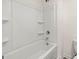 A clean white bathtub with an overhead shower at 572 Whitman Ln # 19, Stockbridge, GA 30281