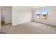 Bright bedroom with neutral carpet, a large window, and white walls offering a cozy atmosphere at 572 Whitman Ln # 19, Stockbridge, GA 30281