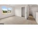 Well-lit bedroom with neutral carpet, a window with a view, and a closet at 572 Whitman Ln # 19, Stockbridge, GA 30281
