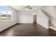 Expansive living area with staircase features wood flooring, abundant natural light and views of the landscape at 572 Whitman Ln # 19, Stockbridge, GA 30281