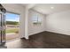 Bright living room with hardwood floors, large windows, and a welcoming open doorway at 572 Whitman Ln # 19, Stockbridge, GA 30281