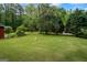 Large, lush backyard with mature trees, a swing set and plenty of space for outdoor activities and entertaining at 725 & 761 School Road, Hampton, GA 30228