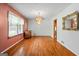 Bright dining room with hardwood floors, a large window, and vintage chandelier at 725 & 761 School Road, Hampton, GA 30228
