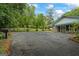 Large driveway leads to home with stone accents and connected carport at 725 & 761 School Road, Hampton, GA 30228