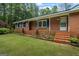 A quaint brick home features a well-maintained lawn and inviting entryway at 725 & 761 School Road, Hampton, GA 30228