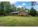 Brick home featuring a blue metal roof, matching shutters and a large lawn at 725 & 761 School Road, Hampton, GA 30228