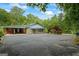 Home with stone accents, attached carport, and large driveway at 725 & 761 School Road, Hampton, GA 30228