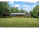 Brick home featuring a blue metal roof, matching shutters and a large lawn at 725 & 761 School Road, Hampton, GA 30228
