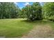 Spacious front yard with mature trees, lush greenery, and a well-maintained lawn, offering plenty of outdoor space at 725 & 761 School Road, Hampton, GA 30228